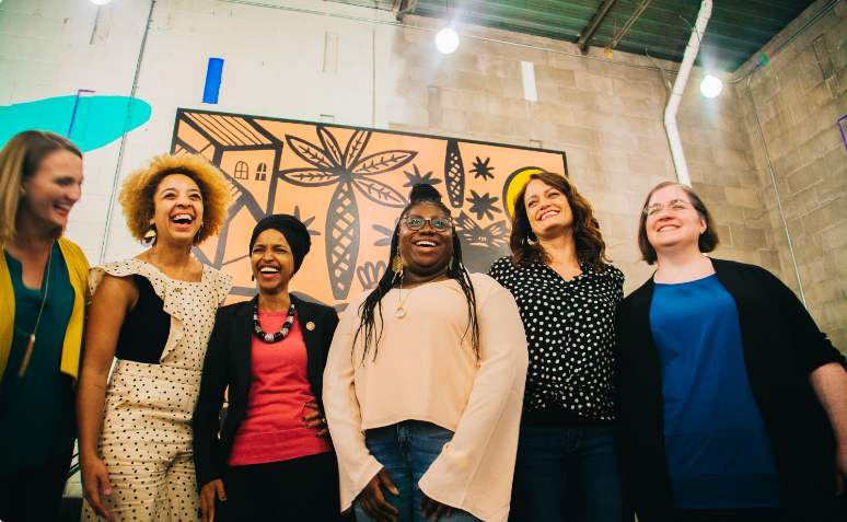 Ilhan laughing with group of women