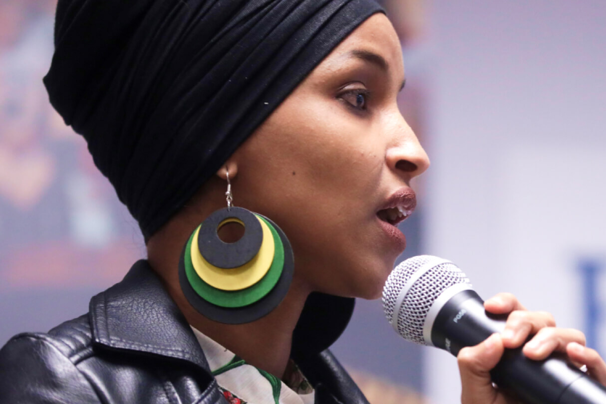 Ilhan Omar speaking into a microphone